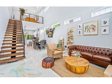 Inviting living room boasts an open staircase, high ceilings, and stylish decor at 601 Lee St, Durham, NC 27701