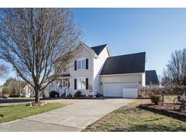 Charming two-story home with a well-maintained lawn and attached two-car garage at 712 Ledgerock Rd, Wake Forest, NC 27587