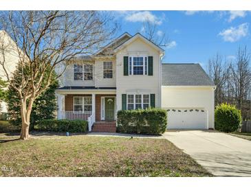 Charming two-story home with a manicured lawn, inviting front porch, and a two-car garage at 938 Widewaters Pkwy, Knightdale, NC 27545