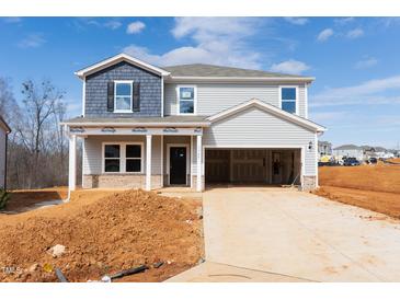New two-story home with blue and gray siding and an attached two-car garage in a construction zone at 1745 Pie Filling Dr, Haw River, NC 27258