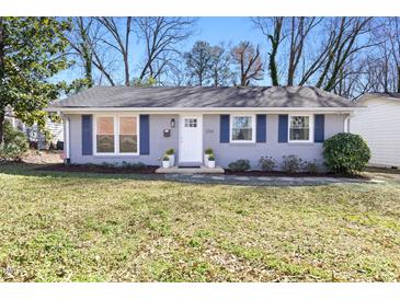 Charming single-story home with a freshly painted exterior, blue shutters, and a well-maintained front lawn at 204 E Murray Ave, Durham, NC 27704