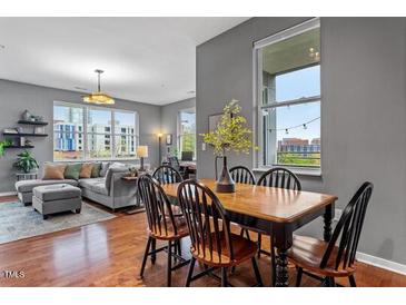 Bright living room with comfortable seating, dining area, and large windows with cityscape views at 506 N Mangum St # 303, Durham, NC 27701