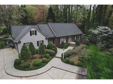Lovely single story home featuring a winding walkway and a beautiful, professionally landscaped front yard at 515 S Woodland Rd, Henderson, NC 27536