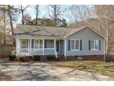Charming single-story home with a welcoming front porch and classic blue shutters at 5900 Damon Ct, Raleigh, NC 27610