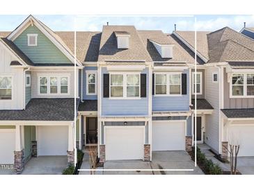 Charming townhome featuring light blue siding, a one-car garage, and well-maintained landscaping at 624 Metro Station, Apex, NC 27502