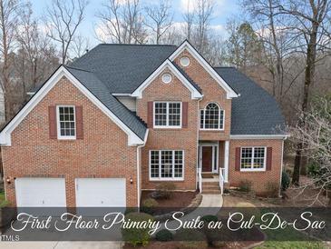 Beautiful two-story brick home featuring a two-car garage, manicured landscaping, and a classic design at 8720 Deerland Grove Dr, Raleigh, NC 27615