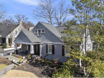 Charming home boasts a cozy front porch, mature landscaping, and classic architectural details at 920 W Johnson St, Raleigh, NC 27605