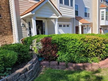 Charming townhome featuring a stone and siding exterior with a covered front porch at 11843 Canemount St, Raleigh, NC 27614