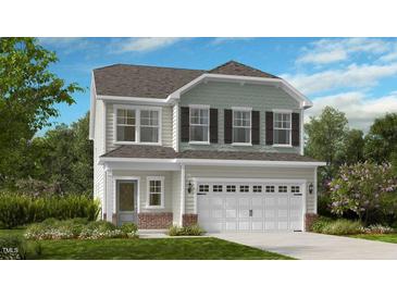Charming two-story home with a two car garage and a landscaped front yard with a brick foundation and a light-colored exterior at 136 Blue Butterfly Dr, Angier, NC 27501