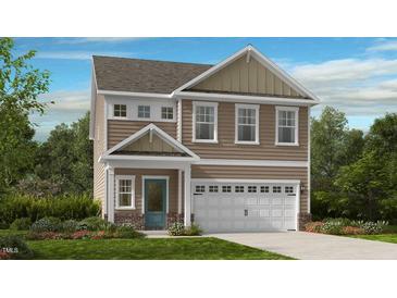 Charming two-story home showcasing light brown siding, white trim and a two car garage at 182 Blue Butterfly Dr, Angier, NC 27501
