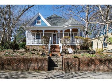 Charming two-story home with a landscaped front yard and welcoming front porch at 207 Linden Ave, Raleigh, NC 27601