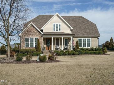 Charming single-Gathering home boasts stone accents, manicured landscaping, and a welcoming front porch at 2609 Packhouse Rd, Zebulon, NC 27597