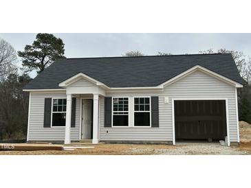 Charming single-story home features gray siding, black shutters, and an attached one-car garage at 272 Johnson Ridge Way, Four Oaks, NC 27524