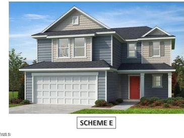 Charming two-story home boasts a classic design with a red front door and a two-car garage at 28 Longdale Dr, Graham, NC 27253