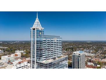 Stunning aerial view of a high-rise building with modern architecture and a clear blue sky backdrop at 301 Fayetteville St # 3205, Raleigh, NC 27601