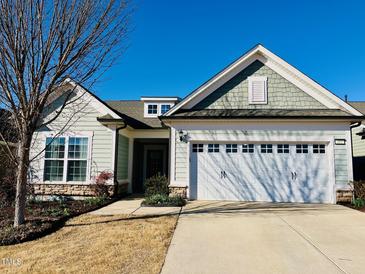 Charming single Gathering home with a two-car garage, manicured lawn, and beautiful landscaping at 111 Kalmia Dr, Durham, NC 27703