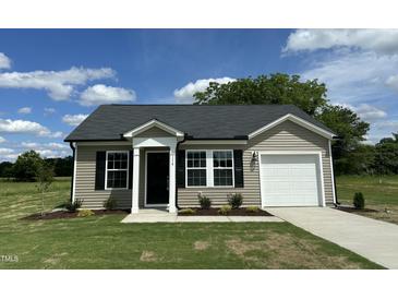 Charming single-story home with vinyl siding, black shutters, and a well-manicured front yard at 114 Johnson Ridge Way, Four Oaks, NC 27524