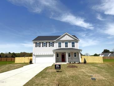 New two-story home featuring a white siding, black shutters, a front-entry two-car garage, and a well-manicured lawn at 120 Whistling Way # Cary Traditiol, Lillington, NC 27546