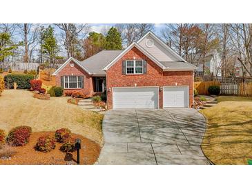 Charming brick home with a two-car garage and well-maintained front yard at 1208 Anora Dr, Apex, NC 27502