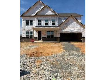 New construction home showing the front of a two-story house with a two-car garage and unfinished landscaping at 1208 Opal Ln # 92, Durham, NC 27705