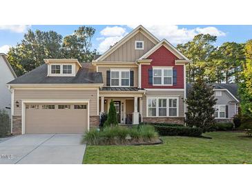 Charming two-story home with a well-manicured lawn, attached garage, and inviting front entrance at 1608 Doubles Ct, Raleigh, NC 27609