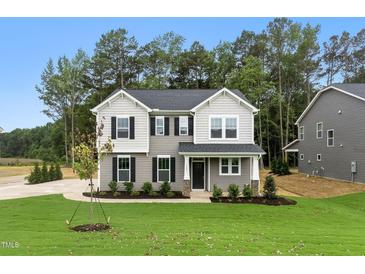 Charming two-story home with gray siding, black shutters, and a well-manicured lawn at 1803 Ballard Rd # Holly Craftsman, Fuquay Varina, NC 27526
