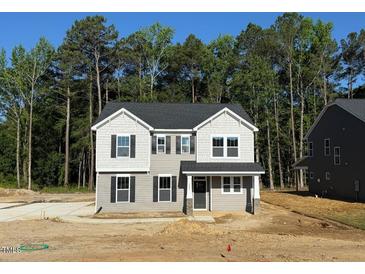 Two-story home with gray siding, black shutters, and a covered front porch on a tree-lined lot at 1803 Ballard Rd # Holly Craftsman, Fuquay Varina, NC 27526