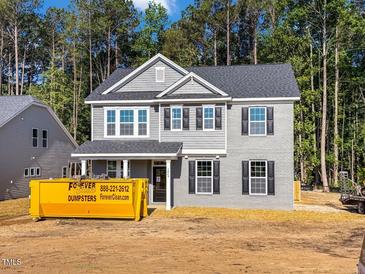 Two-story home featuring gray brick, siding, black shutters, and a covered front porch at 1849 Ballard Rd # Holly Georgian, Fuquay Varina, NC 27526
