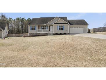 Charming single-Gathering home featuring blue shutters and a two-car garage on a well-maintained lawn at 20 Patterson Dr, Angier, NC 27501