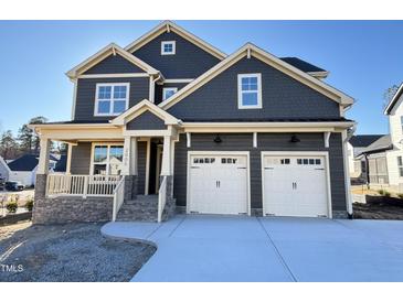 Beautiful two-story home with stone accents, covered porch and two-car garage at 2005 Anna Lilley Dr # 53, Fuquay Varina, NC 27526