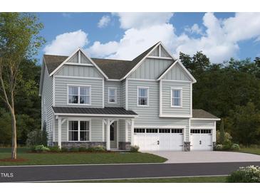 Charming two-story home with light-green siding, a three-car garage, and a welcoming front porch at 2016 Skipping Stone Dr # 162, Durham, NC 27705