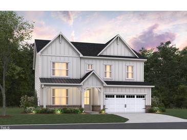 Charming two-story home with a manicured lawn, a two-car garage, and a welcoming covered front porch at 2020 Skipping Stone Dr # 161, Durham, NC 27705