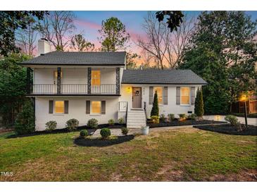 Charming two-story home with landscaped yard and front door wreath at 5613 Ashton Dr, Raleigh, NC 27612