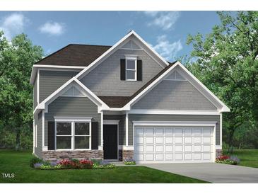 Two-story home with gray siding, stone accents, and a two-car garage at 147 Vega Loop, Sanford, NC 27330