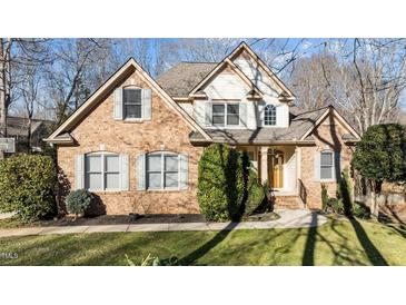 Charming brick home with manicured lawn, complemented by tasteful landscaping and inviting front entrance at 155 Georgetown Woods Dr, Youngsville, NC 27596
