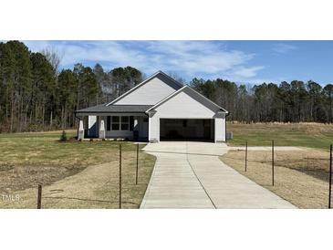 Charming home featuring an attached two-car garage and a well-maintained front yard at 181 Tulipfield Way, Benson, NC 27504