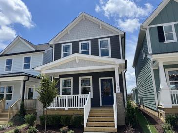 Charming two-story home features a welcoming front porch and a modern blue door at 1903 Plott Balsam Dr, Wendell, NC 27591