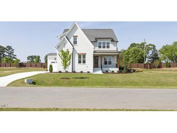 Charming two-story home with a well-manicured lawn and inviting front porch at 3913 Berkeley Town Ln, Fuquay Varina, NC 27526