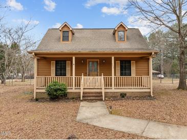 Charming two-story home featuring a inviting front porch, dormer windows and a landscaped yard at 582 Pollyanna Rd, Henderson, NC 27537