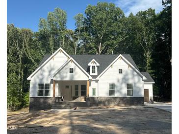 Charming new construction home featuring board and batten siding and a classic front porch at 60 Valebrook Ct, Youngsville, NC 27596