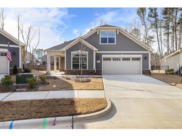 Charming single-Gathering home featuring a two-car garage, stone accents, and well-maintained landscaping at 720 Shell Bank Ct, Cary, NC 27519