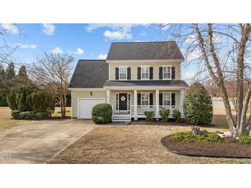 Charming two-story home with a welcoming front porch and well-manicured lawn at 8712 New River Cir, Raleigh, NC 27603