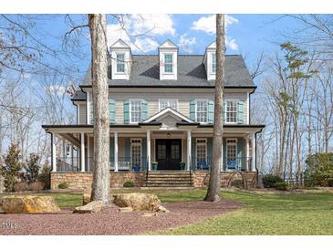 Charming two-story home with stone accents, inviting front porch, and well-manicured lawn at 907 Vintage Hill Pkwy, Durham, NC 27712