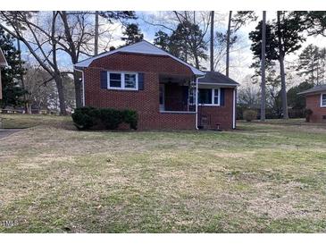 Charming brick home featuring a cozy front porch and well-maintained lawn at 103 W Thorndale Dr, Oxford, NC 27565