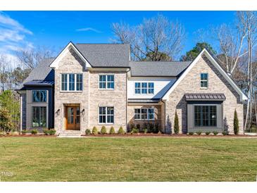 Beautiful two-story brick home with a manicured lawn and a classic architectural design at 149 Bonica Creek Dr, Garner, NC 27529