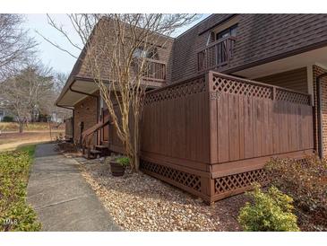 Charming two-story brick condo with a cozy front porch and landscaped surroundings at 159 Finley Forest Dr, Chapel Hill, NC 27517