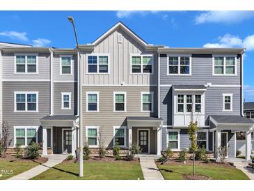 Attractive townhomes feature varied siding, well-manicured lawns and sidewalks for community charm at 1723 Starlit Sky Ln, Cary, NC 27519