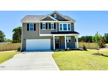 Charming two-story home features a modern gray exterior and a well-manicured lawn at 20 Eagle Crest Court Way # Holly Farmhouse, Lillington, NC 27546