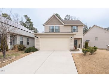 Charming two-story home featuring a two-car garage, neutral siding, and well-maintained landscaping at 207 Kinnakeet Dr, Durham, NC 27704
