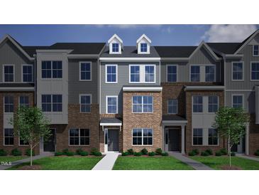 New townhome construction boasts brick and siding facade with dormers and neatly manicured lawns at 328 Chesapeak Commons St # 142, Garner, NC 27529